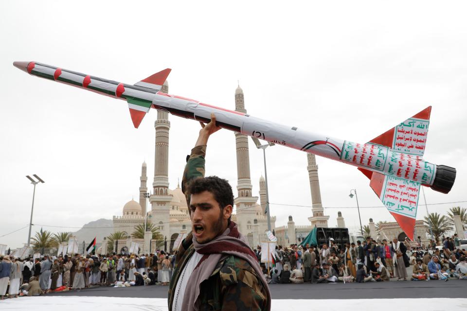 A Houthi supporter raises a mock rocket during a rally against the US and Israel and to support Palestinians in the Gaza Strip, in Sanaa, Yemen on April. 26, 2024.