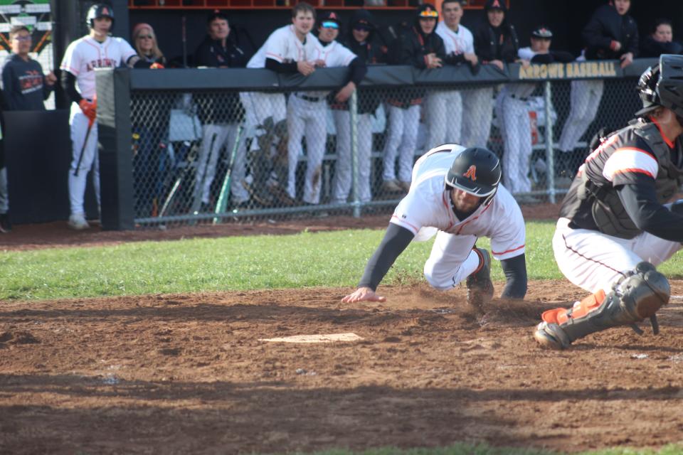 Ashland's Luke Bryant steals home and scores for the Arrows in the third inning.