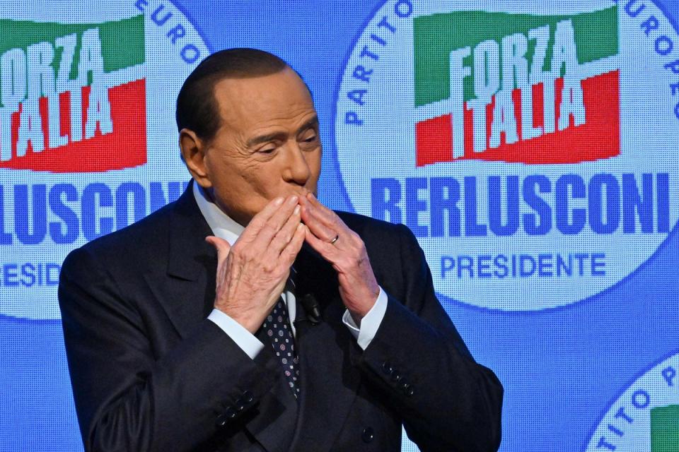 Silvio Berlusconi acknowledges applause on stage in Milan during a meeting at the close of Forza Italia’s campaign for the September general election in 2022 (AFP/Getty)