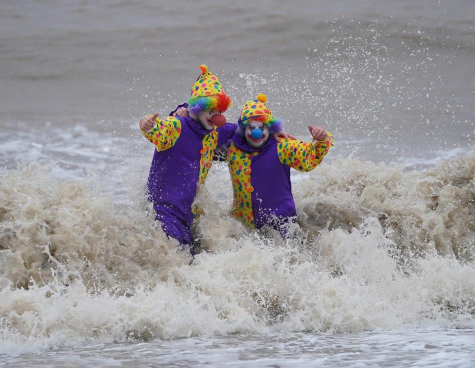 Swimmers Perry Springate and Chris Johnson dressed as clowns for their Christmas dip (Joe Giddens/PA) (PA Wire)