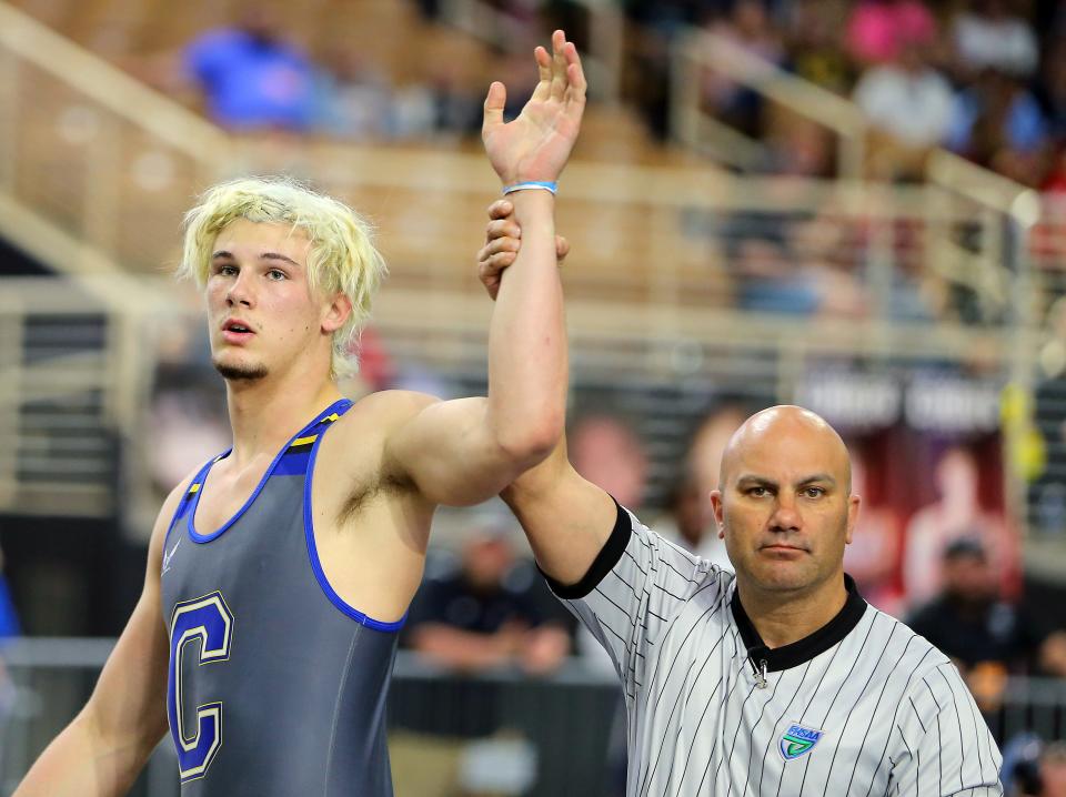 Charlotte High's Cael Newton has his arm raised after winning the Class 2A 220-pound title at the FHSAA State Wrestling Championships on Saturday at Silver Spurs Arena in Kissimmee.