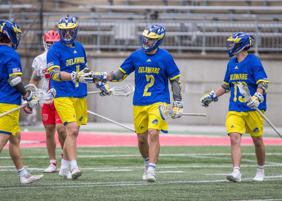 Tye Kurtz is congratulated by teammates after one of his five goals Sunday in Delaware's NCAA loss to Cornell at Ohio Stadium.