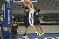 Creighton's Ryan Kalkbrenner scores against Kennesaw State's Cole LaRue, left, and Brandon Stroud during the first half of an NCAA college basketball game in Omaha, Neb., Friday, Dec. 4, 2020. (AP Photo/Kayla Wolf)