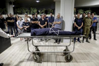 Mourners attend the funeral of Leah Yom Tov, 63, at a cemetery in Rishon Lezion, Israel, Wednesday, May 12, 2021. Yom Tov was killed from a rocket that was fired from Gaza Strip and hit her house in Rishon Lezion on May 11. (AP Photo/Sebastian Scheiner)