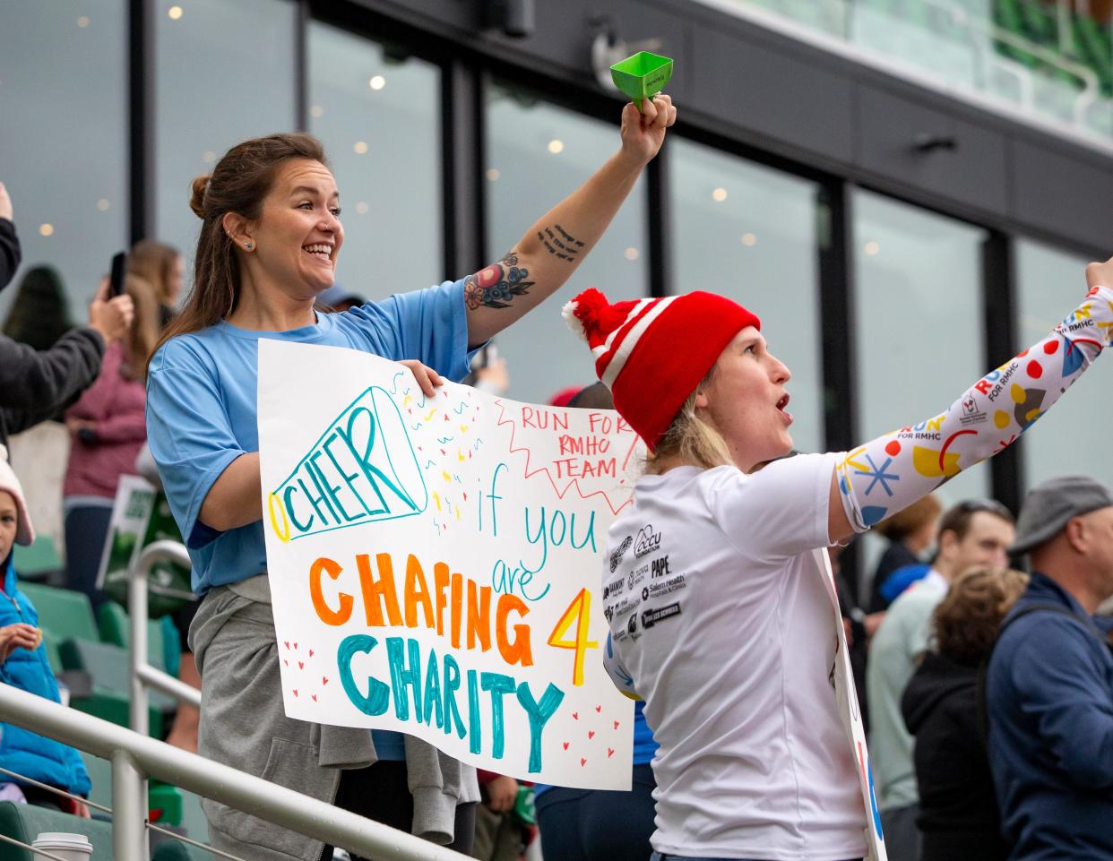 Fans cheer near the finish line of the Eugene Marathon Sunday, April 30, 2023, at Hayward field in Eugene, Ore. 