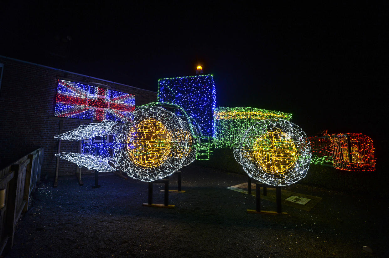 <em>A creative farmer has made an impressive festive tractor using 11,000 sparkling lights (Picture: SWNS)</em>