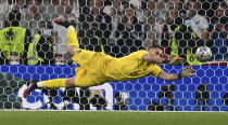 Italy's goalkeeper Gianluigi Donnarumma makes a save against England's Jadon Sancho during penalty shootout of the Euro 2020 soccer championship final match between England and Italy at Wembley Stadium in London, Sunday, July 11, 2021. (Paul Ellis/Pool via AP)