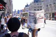 <p>A woman holding a newspaper in NHS rally, which showing Mr. Trump and Mrs. May with the title “shut down trump’s UK visit, June 30, 2018. (Photo: Escapade Leo/Shutterstock) </p>