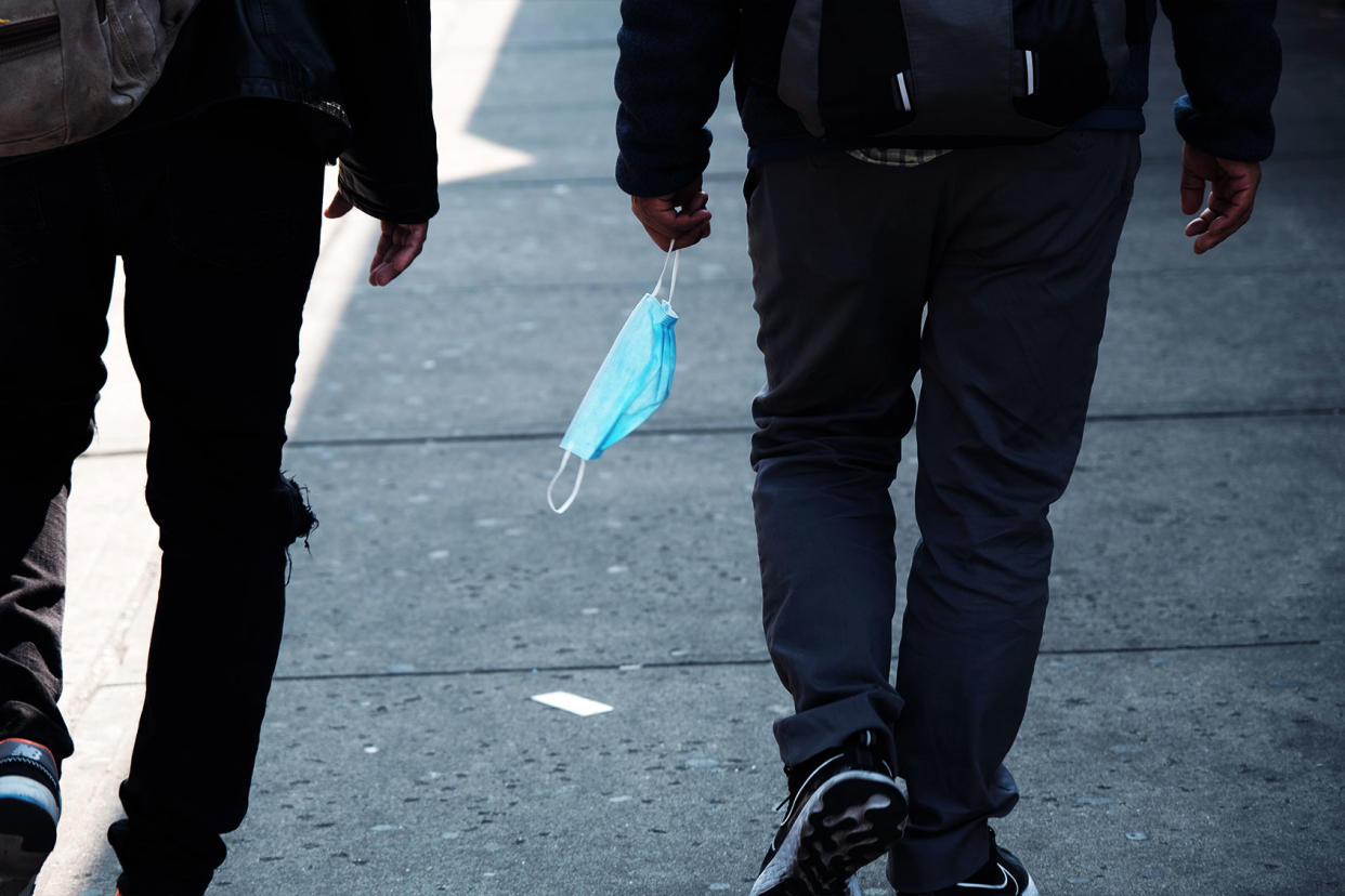 person holding medical mask covid Spencer Platt/Getty Images