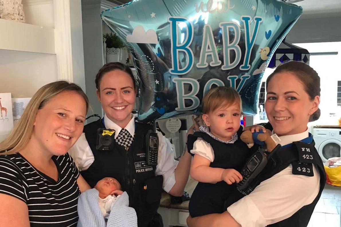 Proud mum Rebecca Fox holding baby Bobby with PC Holly Foran, PC Nicola Devlin and Bobby's sister Marnie: Met Police