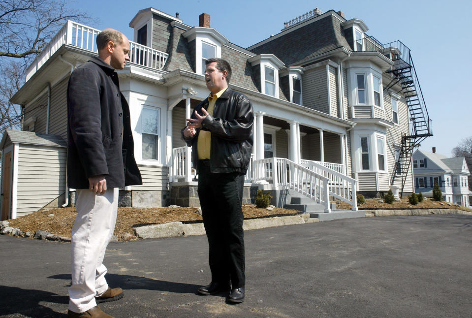 Prospective buyer Jeff Barranco and realtor Michael Walsh talk about home prices at 52 Pierce street. (Credit: Ted Fitzgerald, Boston Herald via Getty Images)