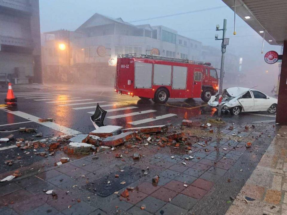 A car was hit by a falling wall amid Typhoon Gaemi (AP)