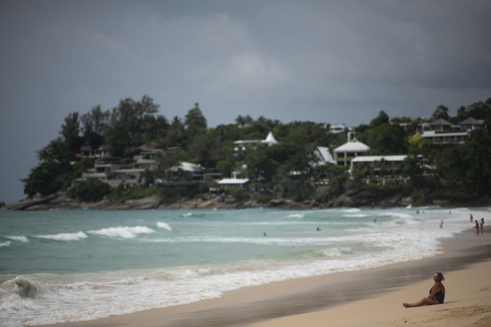 A woman sits on the sand at the Kata Noi Beach in Phuket on October 11, 2018. (Photo by Jewel SAMAD / AFP)        (Photo credit should read JEWEL SAMAD/AFP/Getty Images)