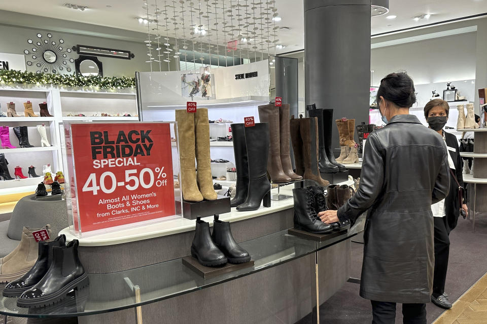 Black Friday shoppers look through merchandise at Macy's in Herald Square on Friday, Nov. 24, 2023, in New York. (AP Photo/Anne D'Innocenzio)