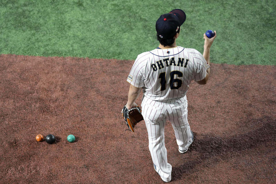 Japan's Shohei Ohtani, warms up during an official training session prior to the Pool B game at the World Baseball Classic (WBC) at the Tokyo Dome Wednesday, March 8, 2023, in Tokyo. (AP Photo/Eugene Hoshiko)