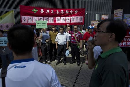 Pro-China supporters attend a rally against the Occupy Central Movement and in support of the government's consultation report on methods for electing the Chief Executive in 2017, outside the Legislative Council in Hong Kong July 15, 2014. REUTERS/Tyrone Siu