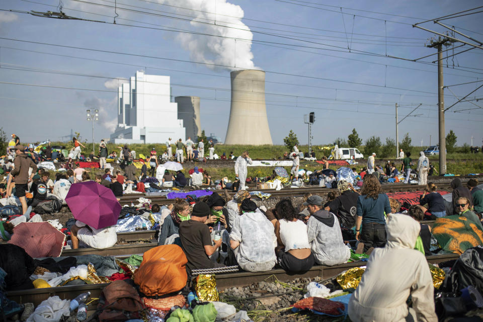 Numerous environmental activists block the tracks of the coal transport railway in Rommerskirchen, Germany, Saturday, June 22, 2019. The protests for more climate protection in the Rhineland continue. Many participants are expected for protests and actions at the Garzweiler opencast mine. Photo by: (Marcel Kusch/dpa via AP)