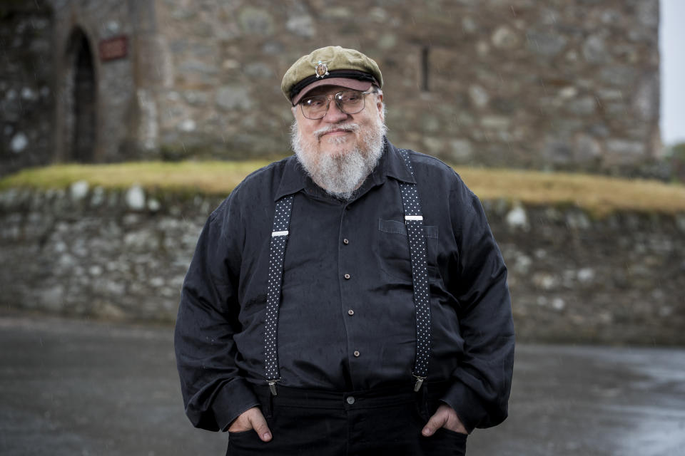 George R. R. Martin, American novelist and short story writer, best known for his series of epic fantasy novels, A Song of Ice and Fire, which was adapted into the HBO series Game of Thrones stands at fictional Winterfell Castle in the grounds of the National Trust property, Castle Ward, where scenes from the series were filmed, before an audience with George at Castle WardÕs theatre this evening. (Photo by Liam McBurney/PA Images via Getty Images)