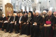 Greek Orthodox Patriarch John X Yazigi of Antioch and All the East (front row, 3rd R) sits next to Syria's Grand Mufti Ahmed Badr al-Din al-Hassoun (front row, 2nd R) at a ceremony to pray for peace in a country plagued by two and a half years of war, during a Christmas mass at al-Maryamyeh church in Damascus December 25, 2013, in this handout photograph released by Syria's national news agency SANA. REUTERS/SANA/Handout via Reuters (SYRIA - Tags: POLITICS RELIGION ANNIVERSARY) ATTENTION EDITORS � THIS IMAGE WAS PROVIDED BY A THIRD PARTY. FOR EDITORIAL USE ONLY. NOT FOR SALE FOR MARKETING OR ADVERTISING CAMPAIGNS. THIS PICTURE IS DISTRIBUTED EXACTLY AS RECEIVED BY REUTERS, AS A SERVICE TO CLIENTS