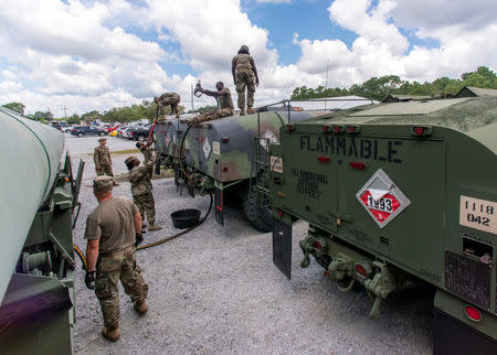 South Carolina National Guard soldiers transfer bulk diesel fuel into fuel tanker trucks for distribution in advance of Hurricane Florence, in North Charleston, South Carolina, U.S. September 10, 2018. U.S. Army National Guard/Sgt. Brian Calhoun/Handout via REUTERS.