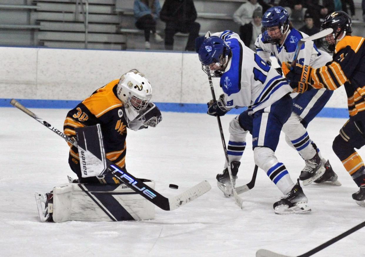 Scituate's Owen Lochiatto, right, takes a shot on Hanover goalie Thomas Perkins, left, during boys high school hockey action at the Hobomock Arena in Pembroke, Wednesday, Feb. 7, 2024.