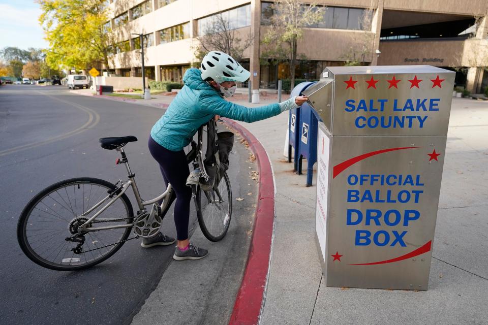 Emily Seibert puts her ballot into a drop box on Oct. 20, 2020, in Salt Lake City.