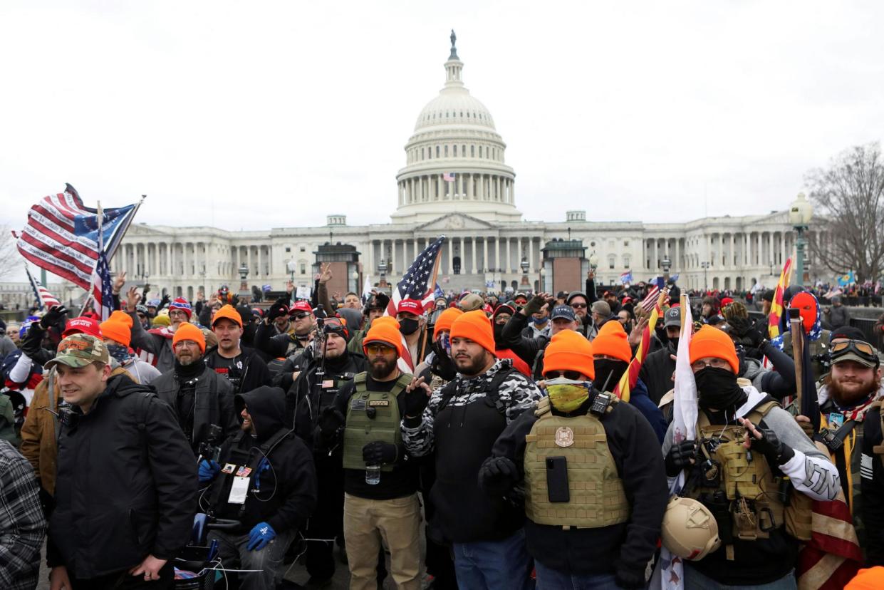 <span>Members of the Proud Boys stand outside the US Capitol in Washington DC on 6 January 2021.</span><span>Photograph: Jim Urquhart/Reuters</span>