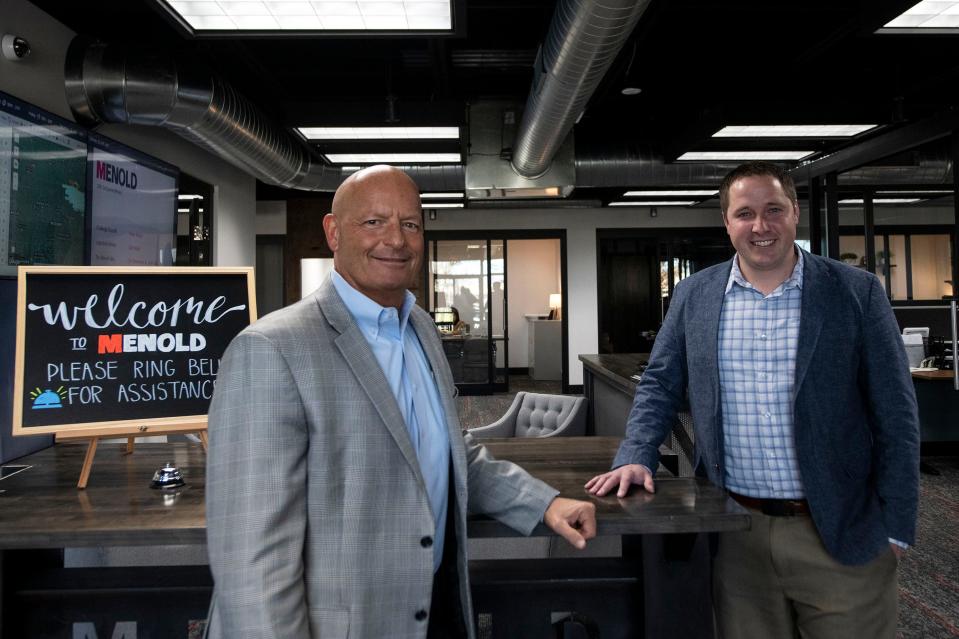 Menold owners Jeff Neihouser and Jon Stapel stand in the front lobby of the construction and restoration business on Nov. 22, 2021.