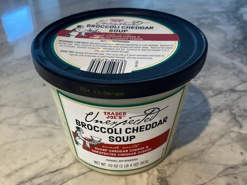 container of trader joe's unexpected broccoli cheddar soup on a kitchen counter