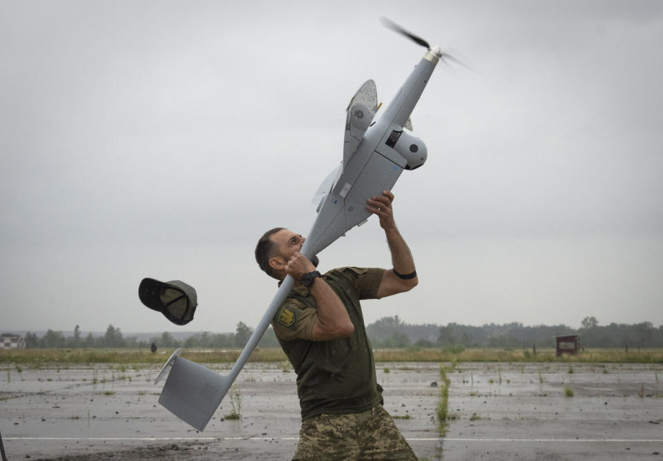 A Ukrainian soldier launches FlyEye WB Electronics SA, a Polish reconnaissance drone, which is in service with the Ukrainian army, in Kyiv region, Ukraine, Tuesday, Aug. 2, 2022. (AP Photo/Efrem Lukatsky)