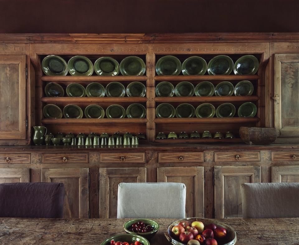 Dankers and his girlfriend, the architect Julie Claes, enjoy entertaining in their burgundy-colored kitchen, which is dominated by an open fireplace and a custom sideboard that stores olive-hued Spanish dishes.