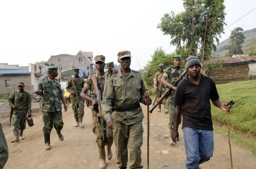 Colonel Sultani Makenga (C), head of the rebel M23 group, tours Bunagana, a town near the border in Uganda, on July 8. United Nations helicopters on Tuesday fired on rebel positions in eastern Democratic Republic of Congo after new clashes broke out there between rebel fighters and loyalist troops, officials said