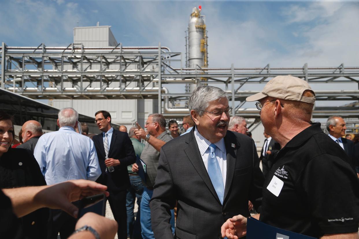 Then-Gov. Terry Branstad chats with guests on April 19, 2017, after a ribbon-cutting ceremony marking the opening of the $3 billion Iowa Fertilizer Co. plant in Wever.