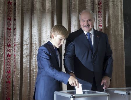 Belarus' President Alexander Lukashenko, accompanied with his son Nikolay, casts his ballot during a presidential election at a polling station in Minsk, Belarus, October 11, 2015. REUTERS/Vasily Fedosenko