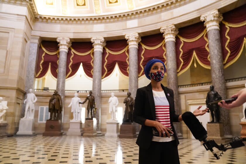 Washington, D.C. - January 12: Rep. Ilhan Omar speaks to reporters in Statuary Hall on Capital Hill on Tuesday, Jan. 12, 2021 in Washington, D.C.. The House of Representatives convened for a session to take up articles of impeachment against President Donald Trump, nearly a week after an insurrectionist mob of pro-Trump supporters breached the security of the nation's capitol while Congress voted to certify the 2020 Election Results. (Kent Nishimura / Los Angeles Times)