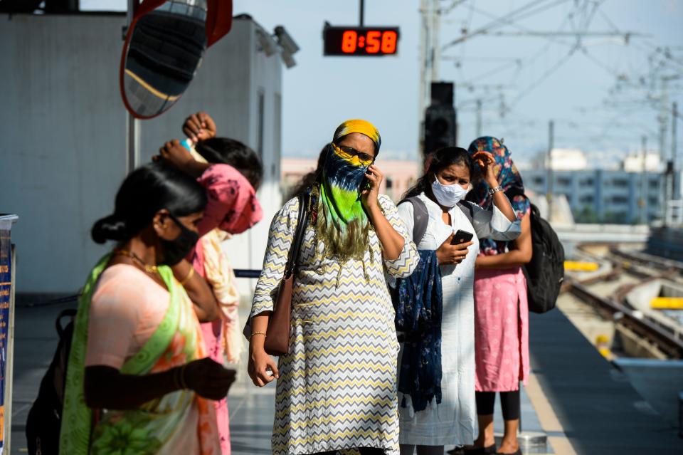 Passengers waits for a train following the resumption of metro services after more than five months of shutdown due to the Covid-19 pandemic, at a station in Hyderabad on September 7, 2020. (Photo by NOAH SEELAM/AFP via Getty Images)