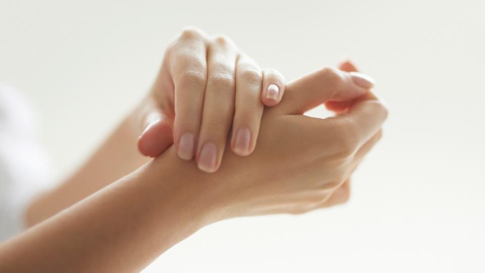 woman rubbing wrists together