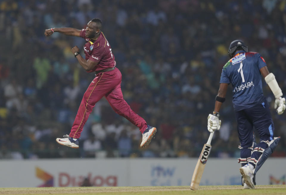 West Indies' Andre Russell celebrate after taking the wicket of Sri Lanka's Kusal Perera during their first Twenty20 cricket match in Pallekele, Sri Lanka, Wednesday, March 4, 2020. (AP Photo/Eranga Jayawardena)