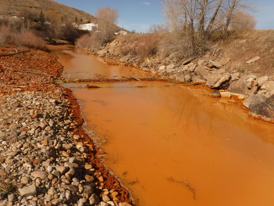 Belt Creek often runs orange when water levels are low due to acid mine drainage from the long abandoned Anaconda Coal Mine. A multi-million dollar project to remove the mine waste is expected to be completed at the end of this summer