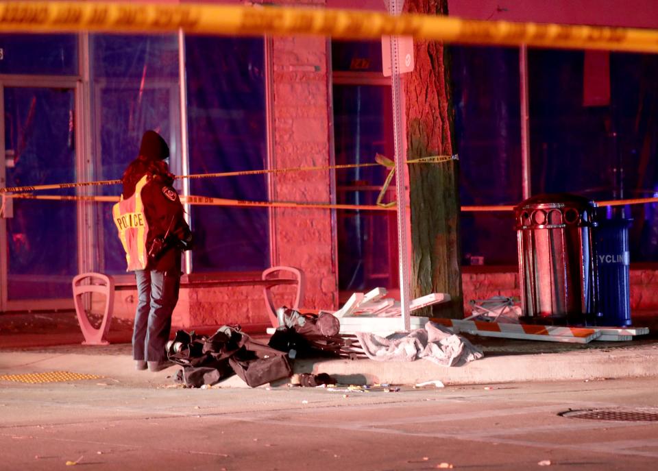 Police investigate at the scene of the Waukesha Christmas Parade where five people were killed Sunday.