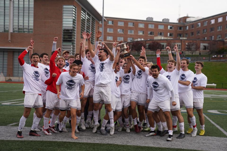 Players from the WPI men's soccer team pose celebrate after the Engineers topped Babson on penalty kicks to win the NEWMAC championship on Saturday.