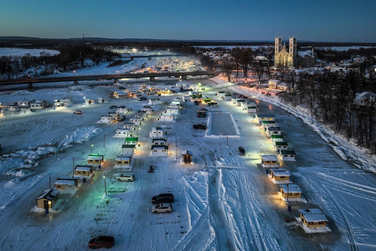 A drone view of some of the more than 350 ice fishing cabins on the Sainte-Anne River in Sainte-Anne-de-la-Pérade, Que., on Jan. 15, 2023.  (Bernard Brault/The Canadian Press - image credit)
