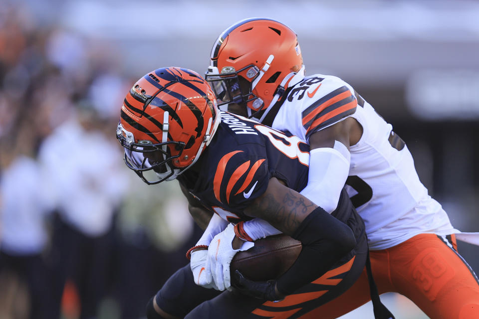 Cincinnati Bengals' Tee Higgins (85) is tackled by Cleveland Browns' A.J. Green (38) during the first half of an NFL football game, Sunday, Nov. 7, 2021, in Cincinnati. (AP Photo/Aaron Doster)