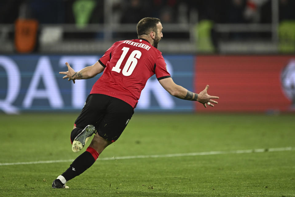 Georgia's Nika Kvekveskiri celebrates after scoring his side's fourth goal during a penalty shootout at the end of the Euro 2024 qualifying play-off soccer match between Georgia and Greece at the Boris Paichadze National Stadium in Tbilisi, Georgia, Tuesday, March 26, 2024. (AP Photo/Tamuna Kulumbegashvili)