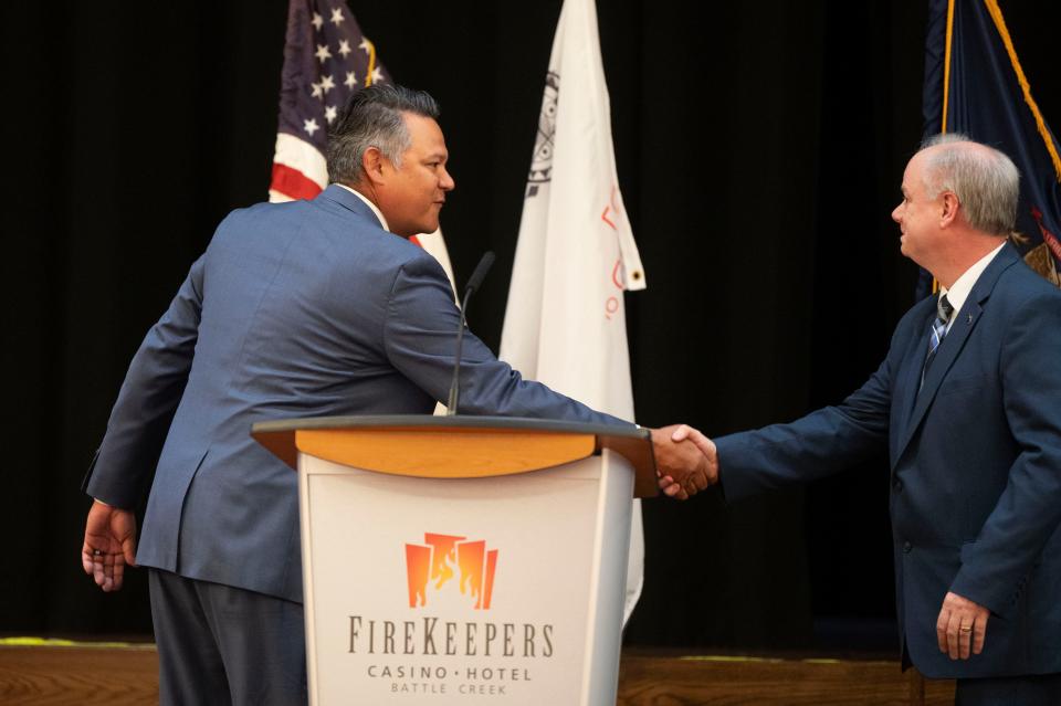 FireKeepers CEO Frank Tecumseh and Michigan Economic Development Corporation Strategic External Relations Advisor Brad Heffner shake hands during revenue sharing ceremonies at FireKeepers Casino Hotel on Thursday, March 14, 2024.