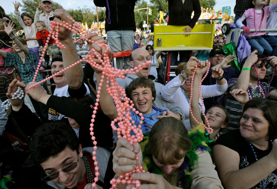 Revelers grab for beads during the Krewe of Endymion Mardi Gras parade in New Orleans Saturday, Feb. 2, 2008. Carnival revelers were greeted with good weather today in the weekend before Fat Tuesday Feb. 5.