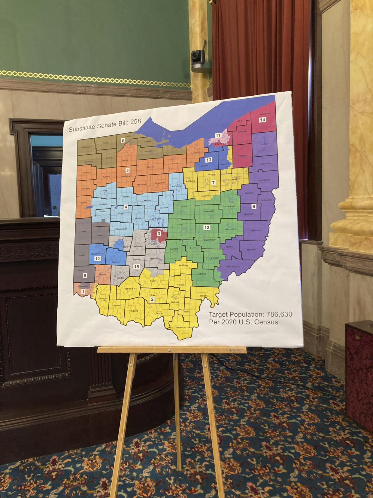 FILE—A map of Ohio congressional districts sits on display during a committee hearing at the Ohio Statehouse in Columbus, Ohio in this file photo from Nov. 16, 2021. On Friday, Jan. 14, 2022, the Ohio Supreme Court rejected a new map of the state's 15 congressional districts as gerrymandered, sending the blueprint back for another try. The 4-3 decision returns the process to the powerful Ohio Redistricting Commission. (AP Photo/Julie Carr Smyth, File)