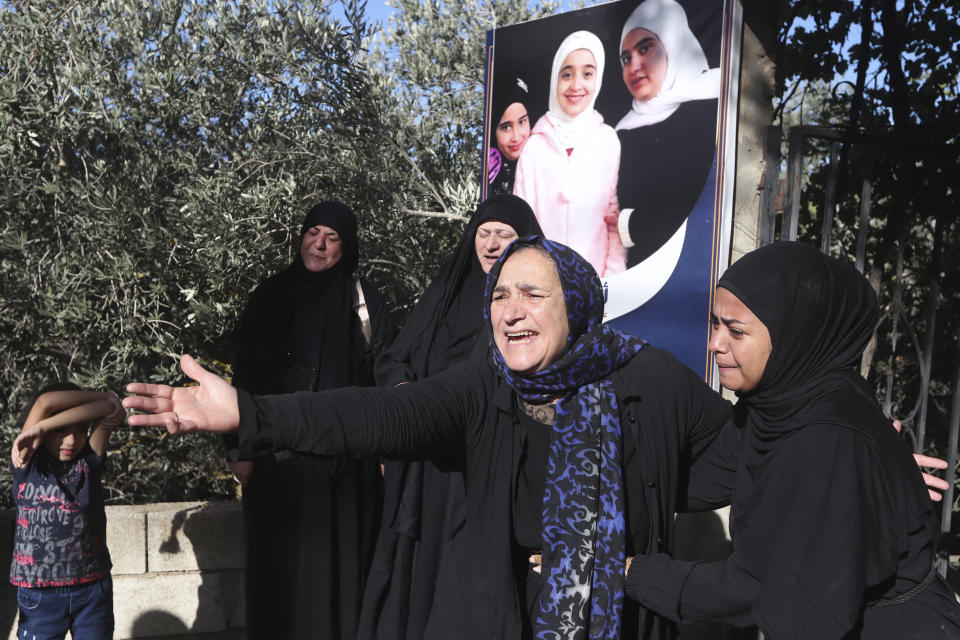 Relatives of the victims who were killed by an Israeli airstrike, mourn during their funeral procession in the town of Ainata, a Lebanese border village with Israel in south Lebanon, Tuesday, Nov. 7, 2023. A Lebanese woman and her three grand daughters were laid to rest in their hometown in southern Lebanon two days after they were killed in an Israeli drone strike while in a car near the Lebanon-Israel border. (AP Photo/Mohammed Zaatari)