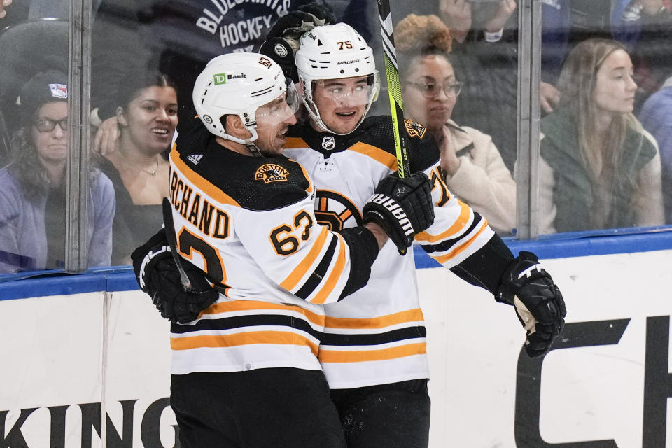 Boston Bruins' Connor Clifton, right, celebrates with teammate Brad Marchand after scoring a goal during the third period of an NHL hockey game against the New York Rangers Thursday, Jan. 19, 2023, in New York. The Bruins won 3-1. (AP Photo/Frank Franklin II)