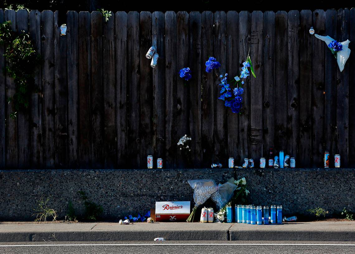 An impromptu memorial of beer, candles, flowers and a cigar has been left on the sidewalk and fence near the site where Jordan Patrick Taylor, 30, of Pasco was fatally shot July 14, 2022 on West Clearwater Avenue near South Kellogg Street in Kennewick. Police investigators say the incident was a motorcycle gang-related shooting.